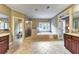 Bright bathroom with a glass walk-in shower and a free standing tub in front of a large window at 2953 Kings Walk Ave, Marietta, GA 30062