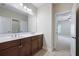 Spacious bathroom features double sinks, dark wood cabinets, and a door to the main bedroom at 2953 Kings Walk Ave, Marietta, GA 30062