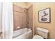 Cozy bathroom featuring a shower-tub combination with tile surround and an art piece at 2953 Kings Walk Ave, Marietta, GA 30062