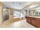 Bright bathroom with a glass walk-in shower and a free standing tub in front of a large window at 2953 Kings Walk Ave, Marietta, GA 30062