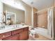 Neutral bathroom features a shower-tub combination, tile flooring, and dark wood cabinets at 2953 Kings Walk Ave, Marietta, GA 30062