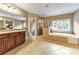 Spa-like bathroom with soaking tub, tiled shower, and granite-topped vanity at 2953 Kings Walk Ave, Marietta, GA 30062