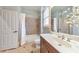 Neutral bathroom features a shower over a bathtub and a large vanity with a decorative faucet and a framed mirror at 2953 Kings Walk Ave, Marietta, GA 30062