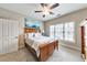 Bedroom featuring a ceiling fan, a queen bed, carpet, and a painting of sailboats above the bed at 2953 Kings Walk Ave, Marietta, GA 30062