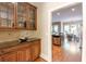 Butler's pantry with wood cabinets, granite countertops, and glass display shelves at 2953 Kings Walk Ave, Marietta, GA 30062