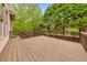 Spacious wooden deck with railing, offering a relaxing outdoor living space surrounded by lush greenery and mature trees at 2953 Kings Walk Ave, Marietta, GA 30062