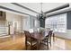 Elegant dining room featuring grey walls, hardwood floors, and a modern chandelier at 2953 Kings Walk Ave, Marietta, GA 30062