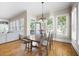 Sunlit dining area with rustic table, a view of the outside deck, and hardwood floors at 2953 Kings Walk Ave, Marietta, GA 30062