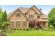 Stunning two-story brick home with manicured lawn and mature landscaping, offering timeless elegance and curb appeal at 2953 Kings Walk Ave, Marietta, GA 30062