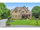 Charming brick home with symmetrical design, complemented by lush greenery and a well-maintained lawn at 2953 Kings Walk Ave, Marietta, GA 30062
