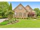 Beautiful two-story brick home with manicured lawn and landscaped gardens, exuding classic charm and curb appeal at 2953 Kings Walk Ave, Marietta, GA 30062