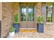 Inviting front entrance with double doors, decorative planters, and a welcoming doormat, creating a warm and inviting atmosphere at 2953 Kings Walk Ave, Marietta, GA 30062