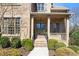 Charming front entrance with brick facade, covered porch, and manicured landscaping at 2953 Kings Walk Ave, Marietta, GA 30062