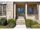 Welcoming front entrance with brick steps, lush landscaping, and a covered porch at 2953 Kings Walk Ave, Marietta, GA 30062