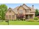 Charming two-story brick home with manicured lawn, mature trees, and a welcoming covered porch at 2953 Kings Walk Ave, Marietta, GA 30062