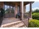 Inviting front porch with brick flooring, brown pillars, and well-maintained landscaping at 2953 Kings Walk Ave, Marietta, GA 30062