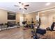 Home gym featuring wood floors, a ceiling fan, and an assortment of exercise equipment at 2953 Kings Walk Ave, Marietta, GA 30062