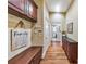 Spacious hallway features wood floors, hallway table, and a sign that reads 'Gathering is a verb' at 2953 Kings Walk Ave, Marietta, GA 30062