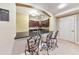 Kitchenette featuring granite countertops, dark wood cabinets, a breakfast bar, and tile flooring at 2953 Kings Walk Ave, Marietta, GA 30062