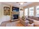 Cozy living room with stone fireplace, built-in shelving, and lots of natural light at 2953 Kings Walk Ave, Marietta, GA 30062