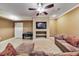 Living room with tan tile flooring, neutral paint colors, and media center with TV at 2953 Kings Walk Ave, Marietta, GA 30062