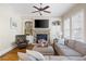 Inviting living room featuring a stone fireplace, built-in shelves, and comfortable seating at 2953 Kings Walk Ave, Marietta, GA 30062