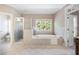 Beautiful main bathroom featuring a shower, soaking tub, double windows, and tiled floors at 2953 Kings Walk Ave, Marietta, GA 30062