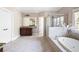 Main bathroom boasting a soaking tub, tiled shower, dual vanities, and ample natural light at 2953 Kings Walk Ave, Marietta, GA 30062