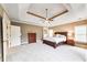 Spacious main bedroom with tray ceiling, neutral carpet, and a large dresser for ample storage at 2953 Kings Walk Ave, Marietta, GA 30062