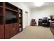 Home office featuring neutral carpeting, neutral paint, built-in shelving and a desk at 2953 Kings Walk Ave, Marietta, GA 30062