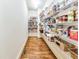 Well-organized pantry featuring ample shelving for storage with hardwood floors at 2953 Kings Walk Ave, Marietta, GA 30062