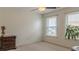 Bedroom featuring carpeted floors, neutral paint, and bright windows with blinds at 3673 Howard Dr, College Park, GA 30337