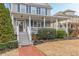 Close-up of charming covered front porch with white columns and a brick walkway at 3673 Howard Dr, College Park, GA 30337