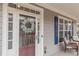 Close-up of front door and window with chair seating on the porch at 3673 Howard Dr, College Park, GA 30337