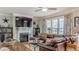 Bright living room features a fireplace, large windows, and a comfortable leather sectional sofa at 3673 Howard Dr, College Park, GA 30337