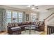 Living room showcasing a large sectional sofa, hardwood floors, and natural light from the large windows at 3673 Howard Dr, College Park, GA 30337