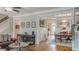 Open-concept living room flows into the dining area, featuring hardwood floors and a staircase at 3673 Howard Dr, College Park, GA 30337