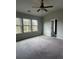 Spacious carpeted bedroom with neutral walls and large windows allowing plenty of natural light at 4373 Trake Way, Ellenwood, GA 30294