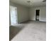 Large carpeted bedroom featuring neutral walls and a doorway to an en-suite bathroom at 4373 Trake Way, Ellenwood, GA 30294