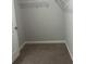 Walk-in closet featuring carpeted floors and wire shelving at 4373 Trake Way, Ellenwood, GA 30294