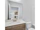 This bathroom features a single vanity with granite countertop, a toilet, and a tub at 6074 Marigold Way, Atlanta, GA 30349