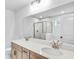 Bathroom with a large mirror, double sinks, and a view into the shower at 6074 Marigold Way, Atlanta, GA 30349