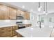 Modern kitchen with a large island, quartz countertops, stainless steel appliances, and wooden cabinetry at 6074 Marigold Way, Atlanta, GA 30349