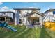 Spacious backyard features lush lawn, covered porch, and a playset at 1405 Lyon Way Dr, Lawrenceville, GA 30044