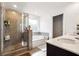 A bathroom with a glass shower, soaking tub, and a white countertop vanity at 1405 Lyon Way Dr, Lawrenceville, GA 30044