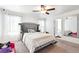 Bedroom featuring a bed with a tufted headboard, a mirror, soft lighting and carpeted floor at 1405 Lyon Way Dr, Lawrenceville, GA 30044