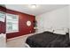 Comfortable bedroom with a large bed, a window, and a dark accent wall at 1405 Lyon Way Dr, Lawrenceville, GA 30044