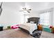Bedroom featuring a bed with a tufted headboard, a ceiling fan, and carpeted floor at 1405 Lyon Way Dr, Lawrenceville, GA 30044
