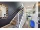 Hallway with stairway has neutral walls and hard wood floors at 1405 Lyon Way Dr, Lawrenceville, GA 30044