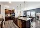 Modern kitchen with a large island, granite countertops, stainless appliances and dark cabinetry at 1405 Lyon Way Dr, Lawrenceville, GA 30044